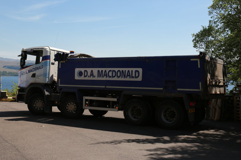 A blue and white D A Macdonald truck
